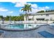 Community pool area with plenty of lounge chairs and a secure fence for relaxation and safety at 500 New York Ave # 22, Dunedin, FL 34698