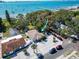 Beautiful waterfront home with lush landscaping and scenic views of the bay with boats and a pier at 5240 31St S Ave, Gulfport, FL 33707