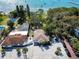 Aerial view of a charming home, pool, pond, and a waterfront with boats, set amidst lush greenery at 5240 31St S Ave, Gulfport, FL 33707