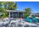 Relaxing back patio featuring pavers, comfortable seating, and views of the lush tropical surroundings and waterfront at 5240 31St S Ave, Gulfport, FL 33707