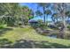 Serene backyard setting with a small pond, lush greenery, and mature trees, offering a peaceful retreat at 5240 31St S Ave, Gulfport, FL 33707