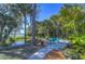 Backyard retreat featuring a peaceful pond and landscaped patio area with views of the water at 5240 31St S Ave, Gulfport, FL 33707