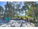 Inviting backyard patio with tranquil water views surrounded by lush, mature landscaping and shade trees at 5240 31St S Ave, Gulfport, FL 33707