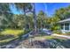 Lush backyard with mature trees, well-maintained lawn, and a paver patio perfect for outdoor living at 5240 31St S Ave, Gulfport, FL 33707