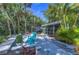 Backyard patio with lush landscaping, mature palm trees, and a serene, private outdoor space at 5240 31St S Ave, Gulfport, FL 33707