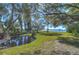 Picturesque backyard with a tranquil pond and stunning water views, complemented by mature shade trees and lush greenery at 5240 31St S Ave, Gulfport, FL 33707