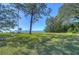 Expansive backyard leading to the waterfront, featuring mature trees that provide shade and picturesque views at 5240 31St S Ave, Gulfport, FL 33707