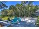 Landscaped patio with waterfront views, a well-manicured lawn, and mature trees in a serene setting at 5240 31St S Ave, Gulfport, FL 33707