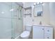 Clean bathroom featuring a glass-enclosed shower, vanity with storage, and white toilet at 5240 31St S Ave, Gulfport, FL 33707