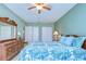 Relaxing bedroom with tropical bedding, wood dresser, and closet space at 5240 31St S Ave, Gulfport, FL 33707
