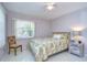 Cozy bedroom featuring neutral walls, a tropical-themed bedspread, and a matching bedside table at 5240 31St S Ave, Gulfport, FL 33707