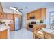 Kitchen with stainless steel appliances, wood cabinetry, speckled floors, and breakfast table at 5240 31St S Ave, Gulfport, FL 33707