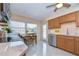 Well-lit kitchen featuring wooden cabinetry, modern appliances, and a cozy dining area with natural light at 5240 31St S Ave, Gulfport, FL 33707