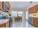 Bright kitchen features updated appliances, wood cabinets, and a casual dining area with view to the yard at 5240 31St S Ave, Gulfport, FL 33707