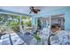 Enclosed lanai with comfortable seating overlooking lush landscaping and a seamless transition to the home's interior at 5240 31St S Ave, Gulfport, FL 33707