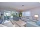 Bright living room showcasing water views, with comfortable seating and access to a screened-in lanai at 5240 31St S Ave, Gulfport, FL 33707