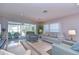 Bright living room with neutral decor, comfortable seating, and a sliding glass door for natural light at 5240 31St S Ave, Gulfport, FL 33707