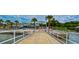 Entrance to Williams Pier in Gulfport, lined with vibrant shops and palm trees, offering a lively atmosphere at 5240 31St S Ave, Gulfport, FL 33707