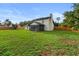 Large backyard offers a screened-in porch and views of the home's rear exterior at 5303 Glen Harwell Rd, Plant City, FL 33566