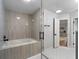 Bathroom with glass-enclosed bathtub/shower combo and a door leading to the rest of the house at 5303 Glen Harwell Rd, Plant City, FL 33566