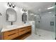 Bathroom featuring dual sink vanity with a wood base cabinet and a glass-enclosed shower at 5303 Glen Harwell Rd, Plant City, FL 33566
