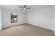Bedroom with a window overlooking the backyard and neutral colored carpet at 5303 Glen Harwell Rd, Plant City, FL 33566