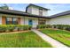 Inviting home exterior with a vibrant blue door and manicured landscaping enhancing curb appeal at 5303 Glen Harwell Rd, Plant City, FL 33566