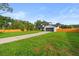 Charming two-story home with well-manicured lawn and a long driveway leading to the garage at 5303 Glen Harwell Rd, Plant City, FL 33566