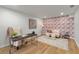 Home office featuring hardwood floors, a desk, a sofa, and floral wallpaper on the back wall at 5303 Glen Harwell Rd, Plant City, FL 33566