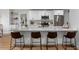 Modern kitchen with white cabinets, a spacious island, and stylish seating for a contemporary living experience at 5303 Glen Harwell Rd, Plant City, FL 33566