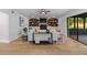 Stylish living room featuring built-in shelving, modern decor, and a cozy ambiance with hardwood floors at 5303 Glen Harwell Rd, Plant City, FL 33566