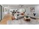 Bright living room with modern furniture, an open floor plan, and hardwood floors for a cozy atmosphere at 5303 Glen Harwell Rd, Plant City, FL 33566