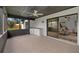 Relaxing screened porch with a ceiling fan, outdoor wet bar, and views of the backyard at 5303 Glen Harwell Rd, Plant City, FL 33566