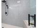 Modern shower with glass enclosure, updated fixtures, and elegant gray tile at 5303 Glen Harwell Rd, Plant City, FL 33566
