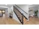 Staircase leading to the second floor with wood stairs and black banister at 5303 Glen Harwell Rd, Plant City, FL 33566