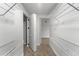 Walk-in closet with white shelving, carpet, and lighting at 5303 Glen Harwell Rd, Plant City, FL 33566