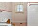 Compact bathroom showcasing vintage tile work and original fixtures including patterned wallpaper at 535 22Nd N Ave, St Petersburg, FL 33704