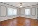 Bright bedroom features hardwood floors, white walls with blue accents, and two windows at 535 22Nd N Ave, St Petersburg, FL 33704