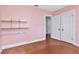Bright bedroom featuring hardwood floors, a built-in shelving unit, and a closet at 535 22Nd N Ave, St Petersburg, FL 33704