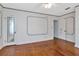 Spacious bedroom with hardwood floors, white walls with blue accents and a ceiling fan at 535 22Nd N Ave, St Petersburg, FL 33704