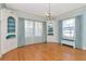 Elegant dining room featuring hardwood floors, a chandelier, and built-in display cabinets at 535 22Nd N Ave, St Petersburg, FL 33704