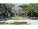Charming two-story home with yellow brick and green awning, surrounded by mature trees at 535 22Nd N Ave, St Petersburg, FL 33704