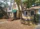 Charming brick home featuring a peaked roof, multiple windows, and a lovely tree in the front yard at 535 22Nd N Ave, St Petersburg, FL 33704