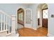 Inviting foyer showcasing hardwood floors, arched doorways, and a staircase with white banisters at 535 22Nd N Ave, St Petersburg, FL 33704