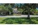 Well-maintained home with mature trees in a lush green lawn across from a park at 535 22Nd N Ave, St Petersburg, FL 33704
