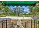 View of the lush front yard and serene park across the street from the home's front porch at 535 22Nd N Ave, St Petersburg, FL 33704
