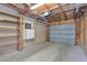 Interior garage view with roll up door, shelves, and plenty of storage space at 535 22Nd N Ave, St Petersburg, FL 33704