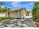 Side view of detached garage showing a white door and plenty of driveway space at 535 22Nd N Ave, St Petersburg, FL 33704