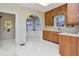 Classic kitchen features wood cabinets and a view of a sunny breakfast nook through an arched doorway at 535 22Nd N Ave, St Petersburg, FL 33704