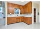 Functional kitchen with wood cabinets, white countertops, and linoleum flooring at 535 22Nd N Ave, St Petersburg, FL 33704